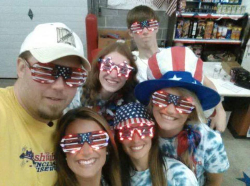 A group of people wearing US flag eye masks  